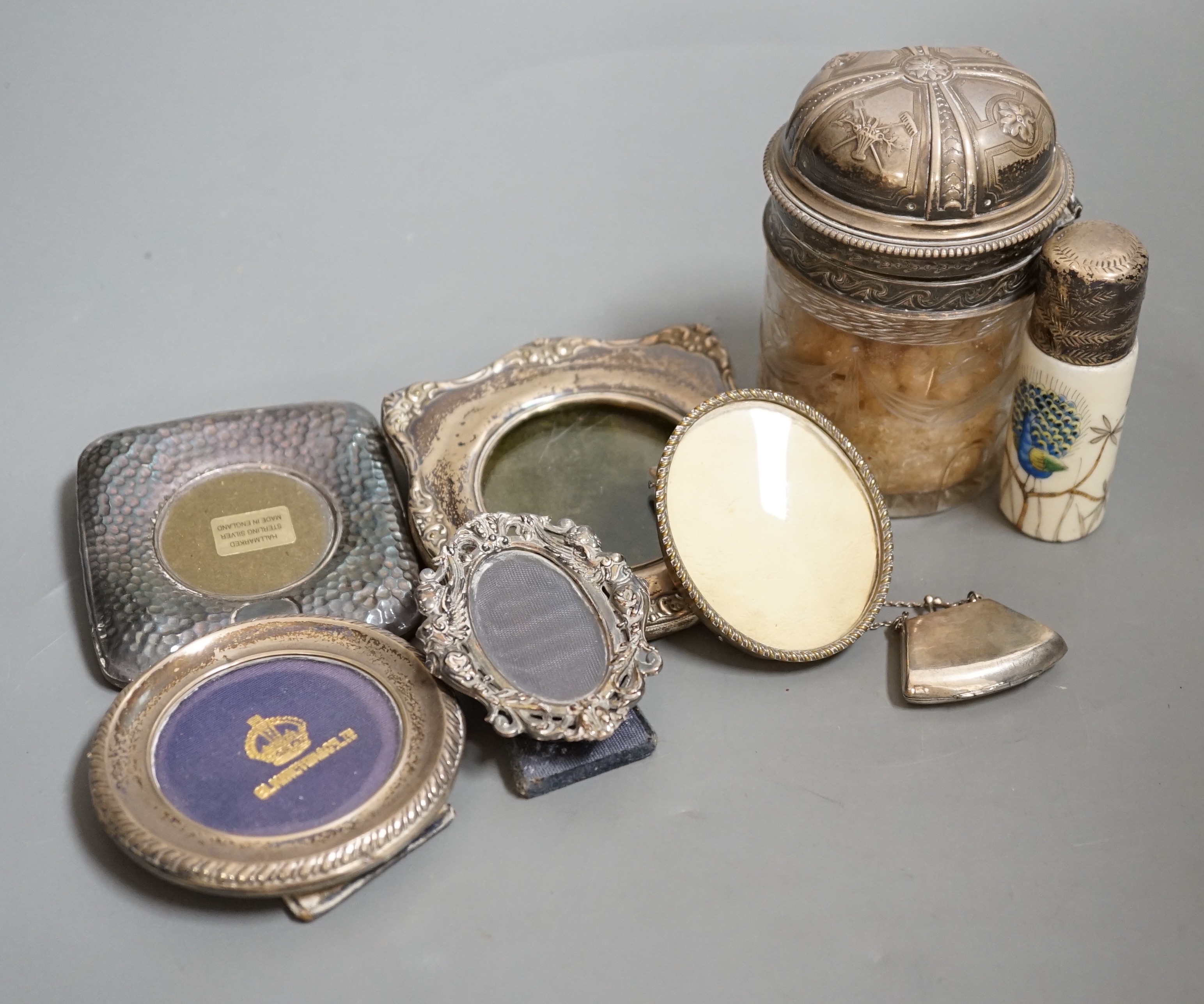 Four small silver mounted photograph frames, one brass frame, a silver lidded jar and one other and a 925 handbag pill box.